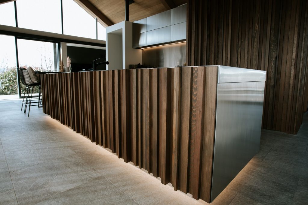 kitchen island with offset wood facade and LED lighting